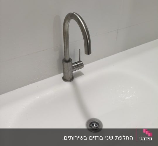 ברז וכיור בחדר אמבטיה לבן ונקי